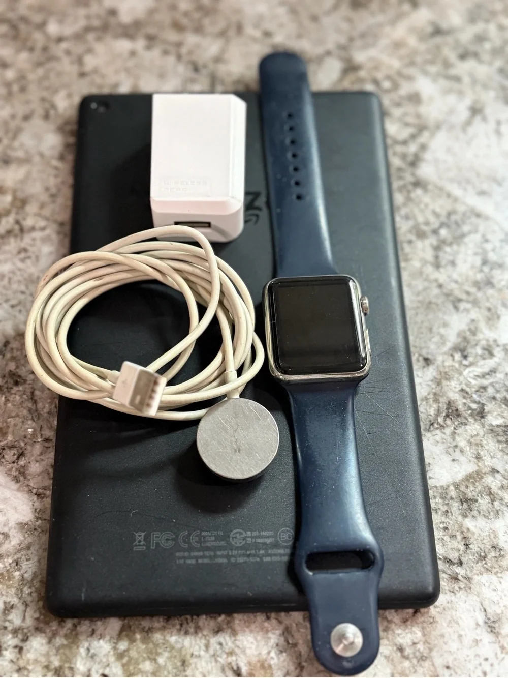 Apple Watch with Navy Blue Sport Band and White Charger
